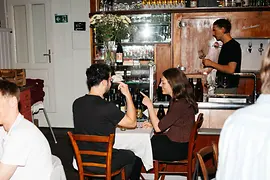 Friends sitting together eating and drinking in a Viennese tavern