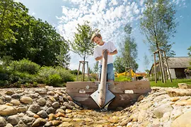 Boy playing in the brook