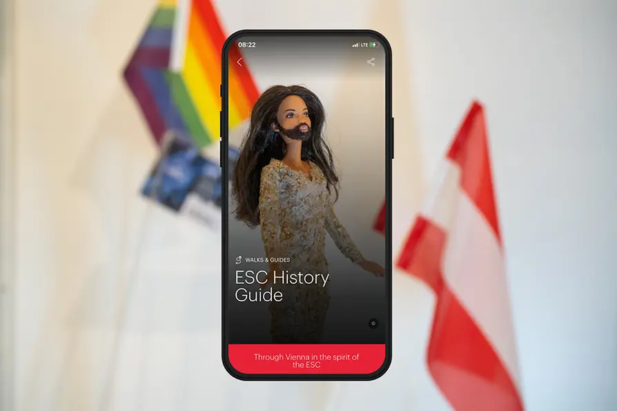 Sujet with Conchita Wurst doll with text: ESC History Guide