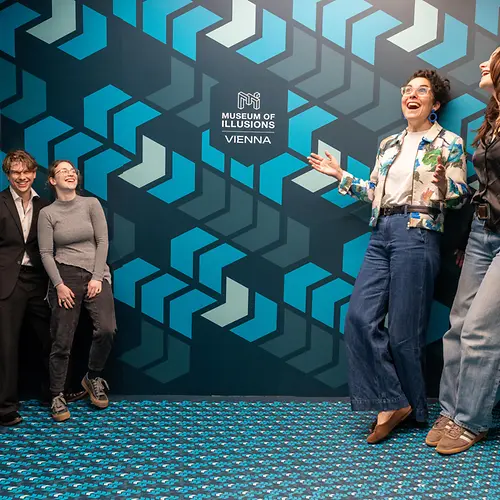 Ames Room with visitors at the Museum of Illusions 