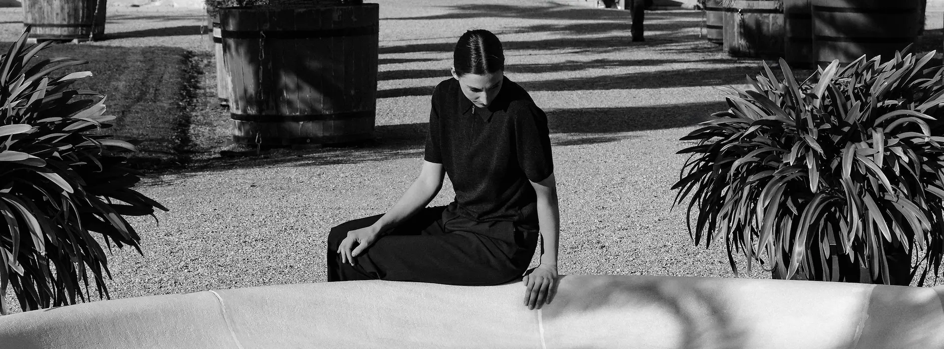 Una mujer sentada junto al estanque de la fuente