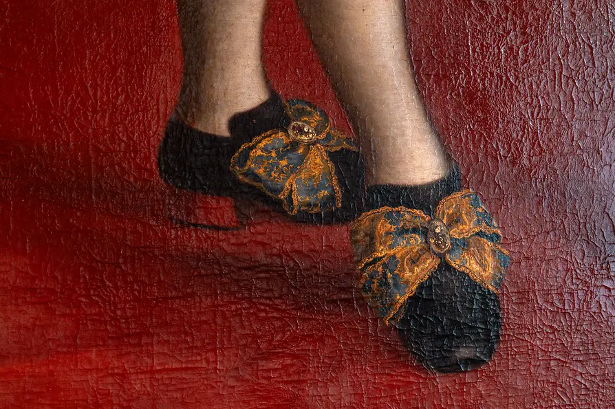 Detalle de una antigua pintura con zapatos
