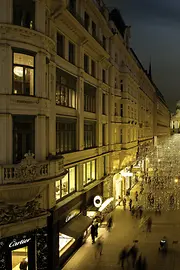 People taking an evening stroll on the atmospherically lit Kohlmarkt
