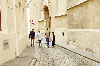 Four people strolling through the old town of Vienna