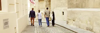 Four people strolling through the old town of Vienna