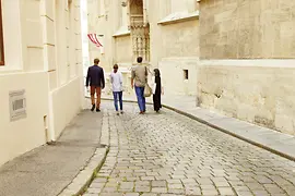 Four people walking through the old town 
