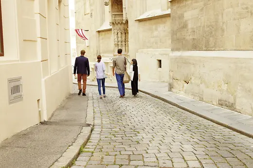 Four people walking through the old town 
