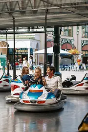 Family riding the autodrome in the Prater