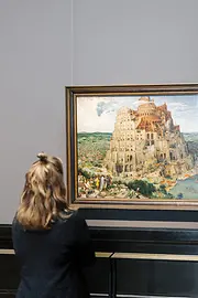 Visitor standing in front of the painting "Tower of Babel" by Pieter Bruegel at the Museum of Fine Arts in Vienna