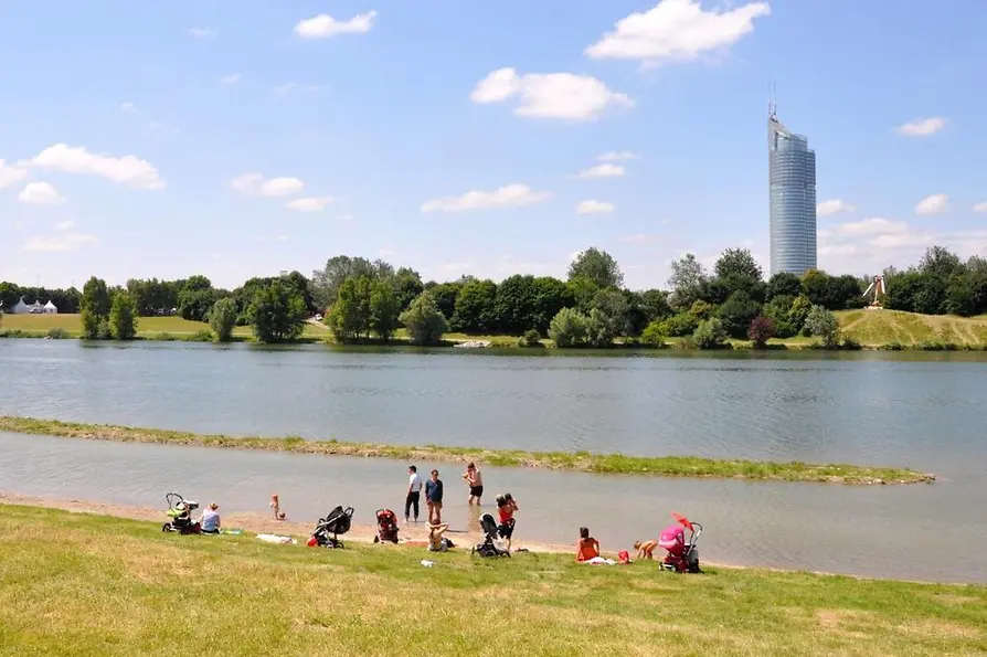 Children in the water at the family bathing beach on Danube Island