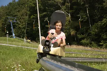 Girl speeding down the toboggan