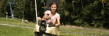 Girl speeding down the toboggan