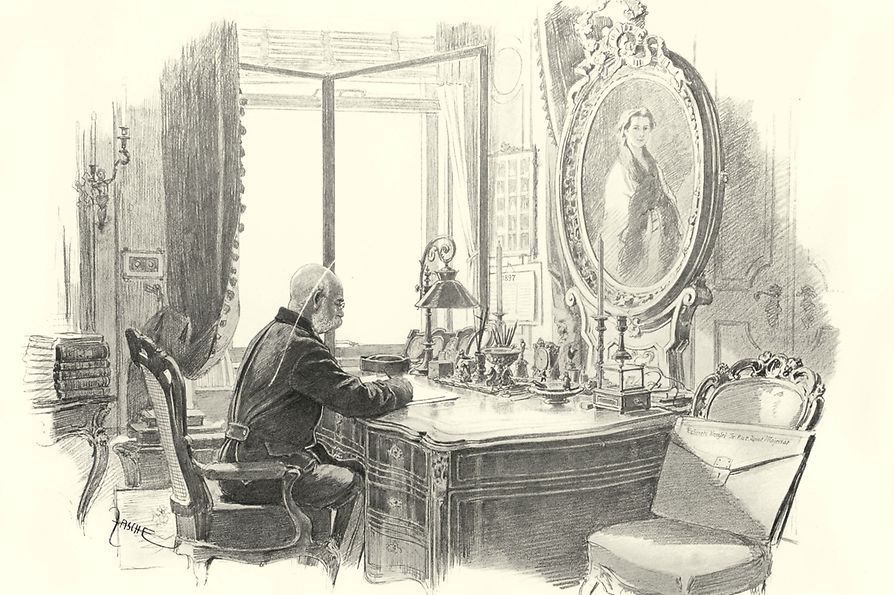 L’imperatore Francesco Giuseppe I siede alla propria scrivania con di fronte un ritratto dell’imperatrice Sissi