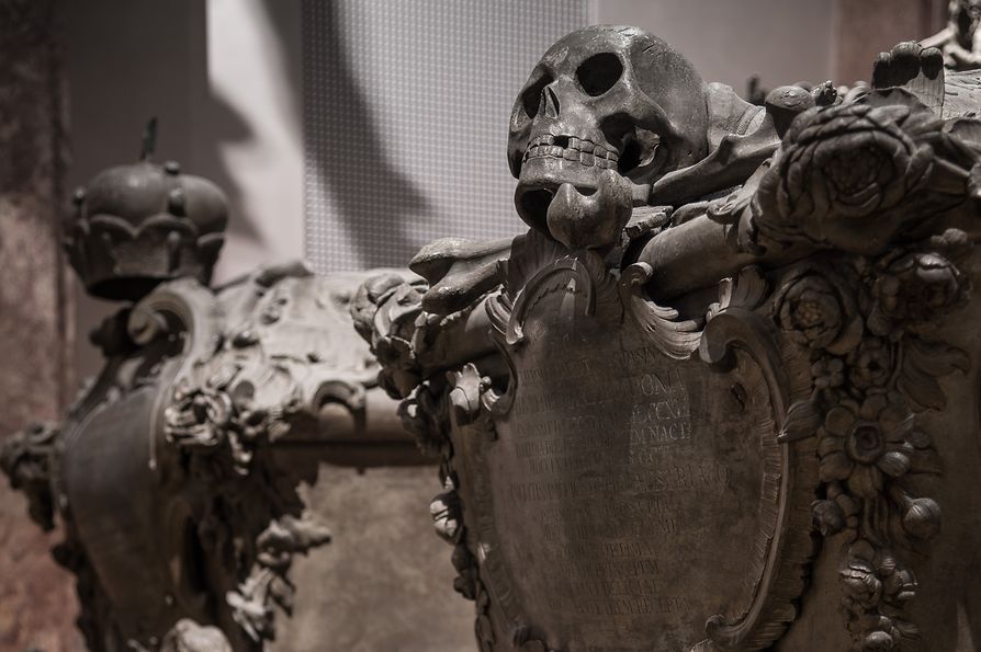 Two caskets with skull sculpture and crown