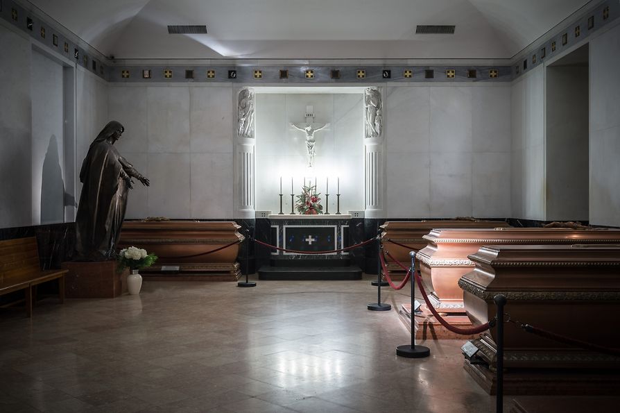 Caskets in hall, sculpture and illuminated altar