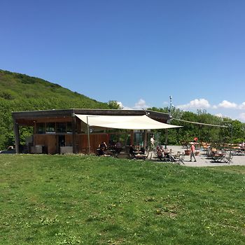 Restaurant on a hill with a terrace in front of it