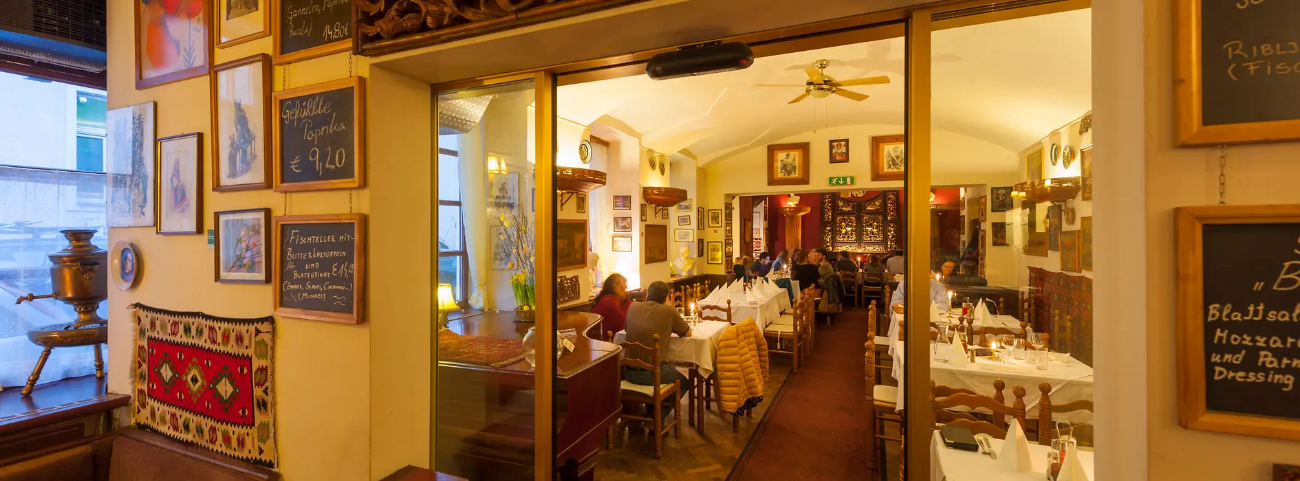 Restaurant Beograd, interior shot with guests and dining tables laid 