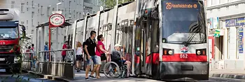 Wheelchair user next to low-floor streetcar
