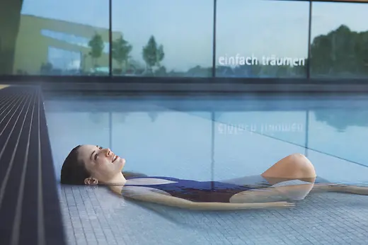Woman relaxing in the waters of Therme Wien, Vienna's thermal baths