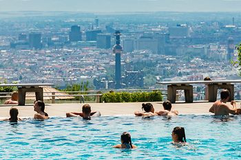 People in a pool with a view on Vienna