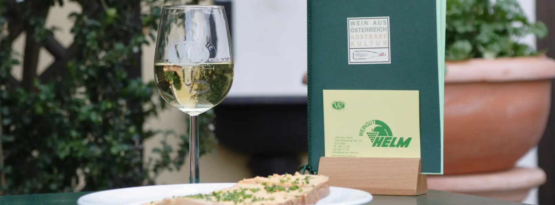 Helm Winery, wine tavern table with a glass of white wine, chive bread, and menu