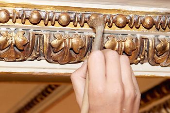 Restoration of the Vienna State Opera. Cleaning decorations with a brush.