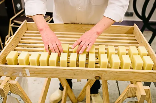 Cut bars of soap before they are packed 