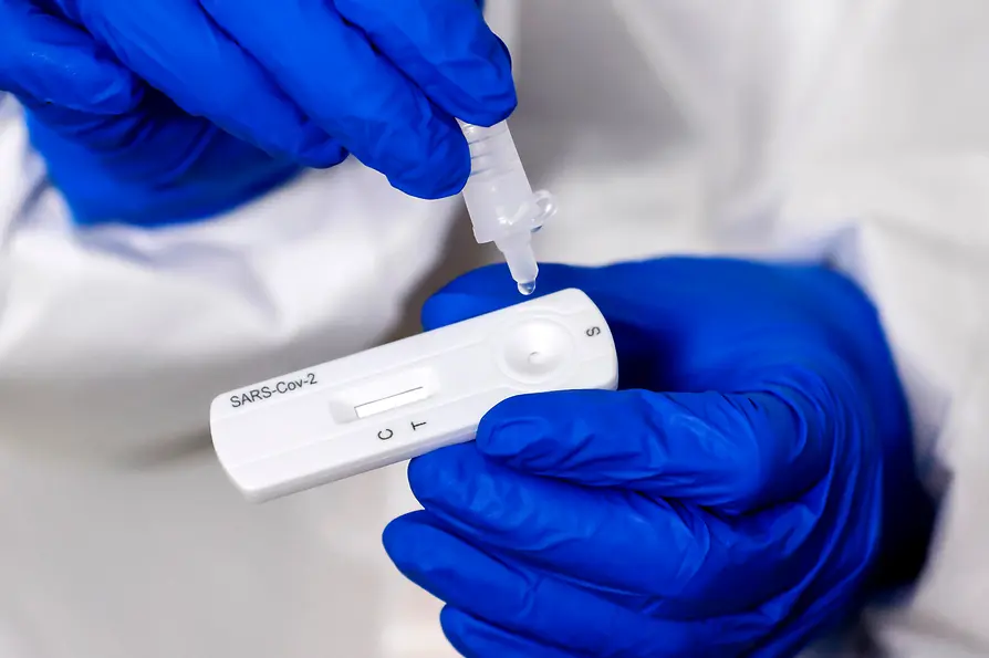 Covid-Teststreifen, auf den Flüssigkeit getropft wird