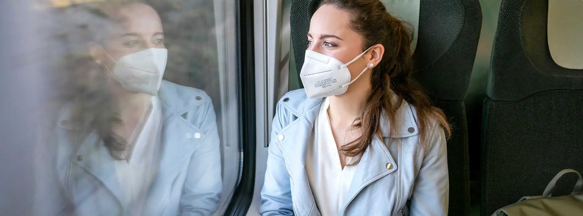 Woman wearing an FFP2 mask on a train