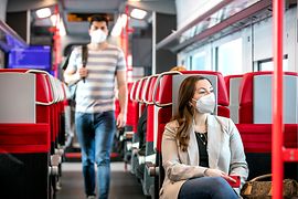 Fahrgäste mit FFP2-Maske im Zug
