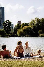 Gänsehäufel lido on the Old Danube: a man, two women, and a child on the beach