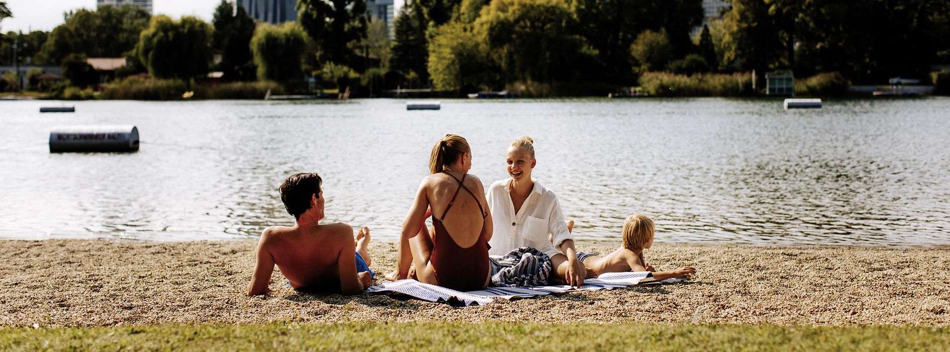 Gänsehäufel lido on the Old Danube: a man, two women, and a child on the beach