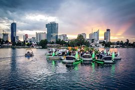 So-called floating islands on the old Danube at the first Floating Concert with Vienna skyline in the background