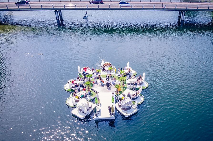 Schwimmende Inseln auf der alten Donau beim Floating Concert mit Brücke im Hintergrund 
