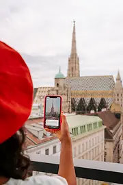 Doamnă cu smartphone şi catedrala Sf. Ştefan pe fundal