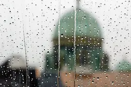 View through a window covered in raindrops
