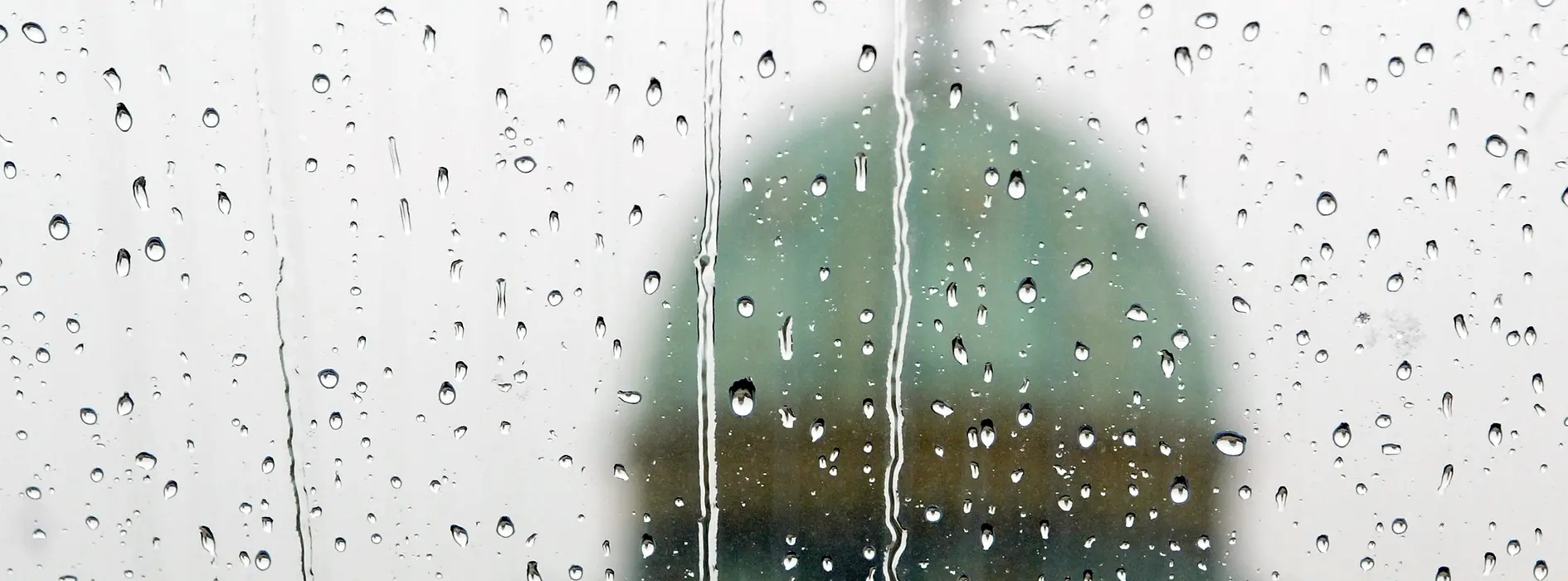 View through a window covered in raindrops