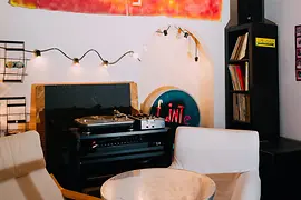 Table with two chairs and a record player
