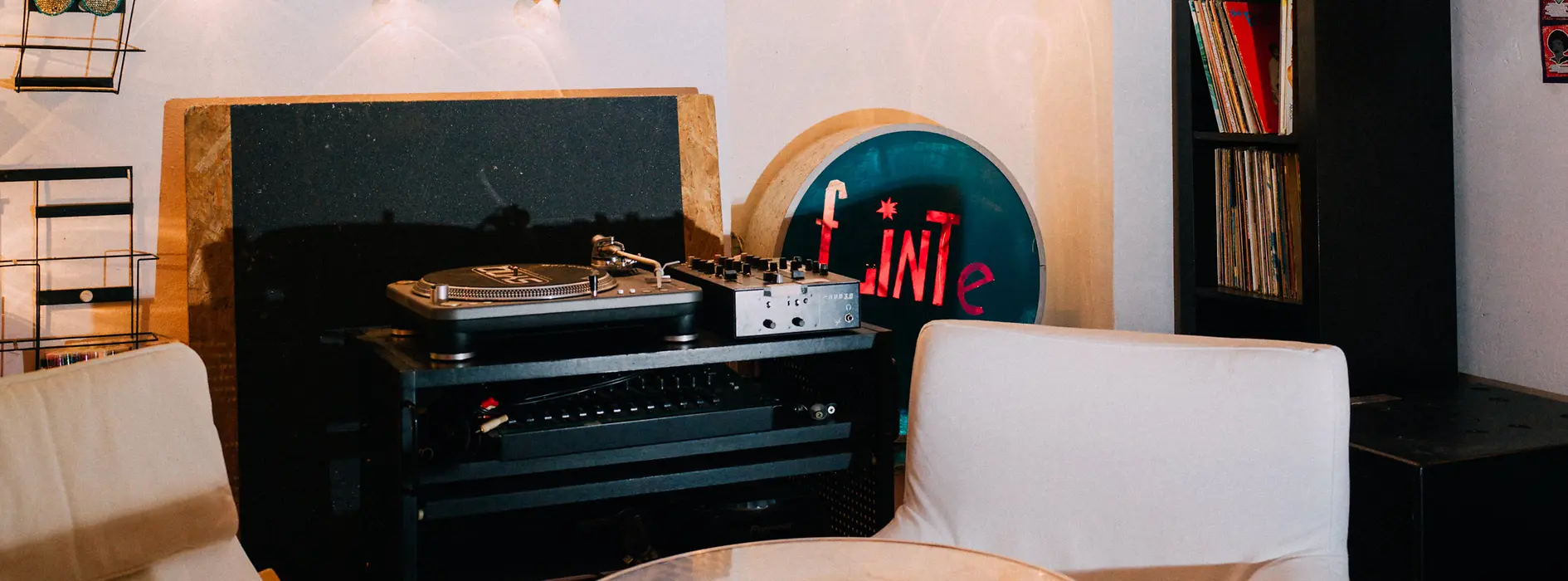 Table with two chairs and a record player