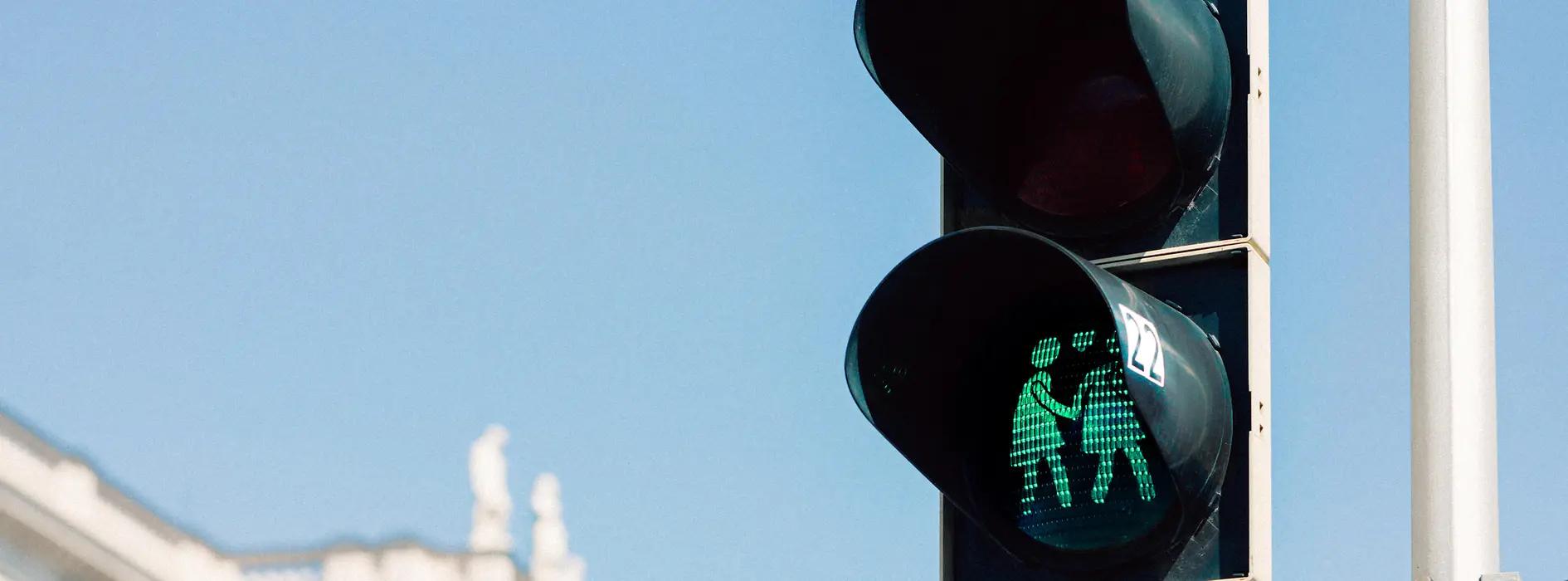 Green traffic light with a same-sex couple