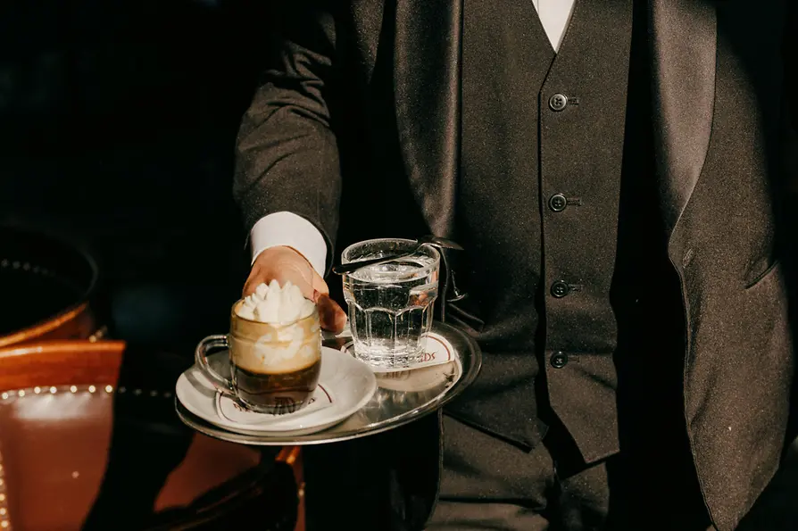 Café Schwarzenberg, waiter serves an "Einspänner" (coffee)