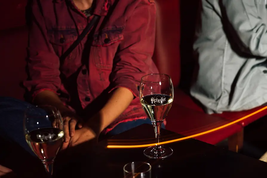 People with drinks at the bar of the Marea Alta