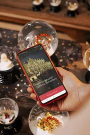 Smart phone with view from ivie, surrounded by snow globes