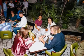 People sitting at a table, drinking cocktails