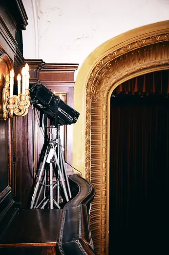 Metro Kino interior shot: Baroque wall lights, spotlights, magnificent proscenium arch