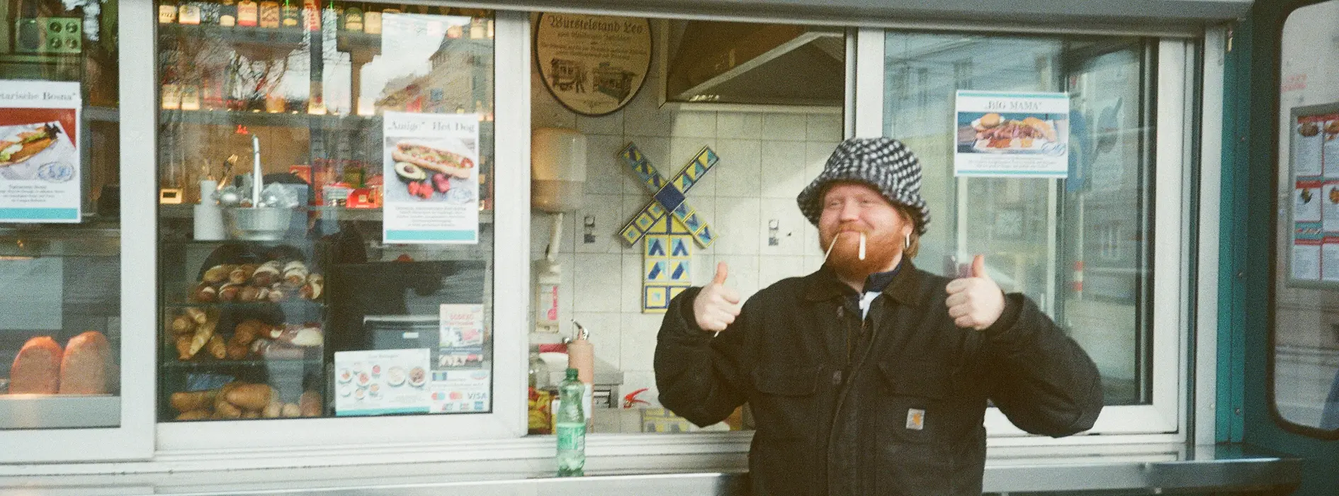 Chef Lukas Mraz in front of a sausage stand