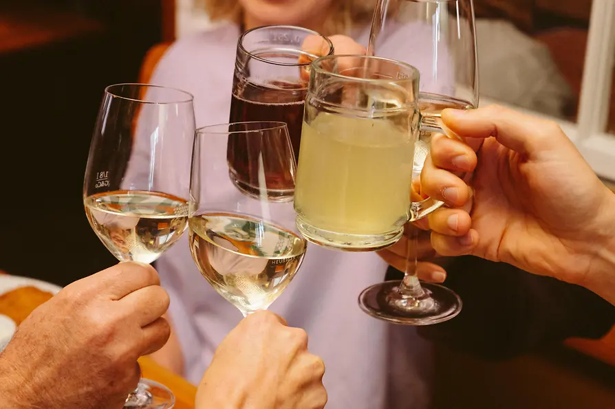 A group raising a toast with wine and grape juice