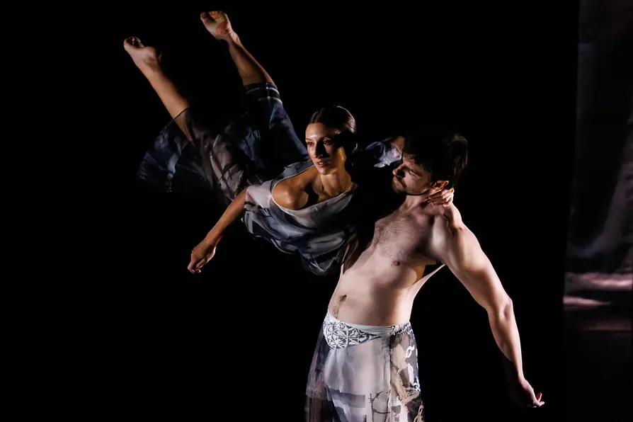 A male dancer lifts a female dancer