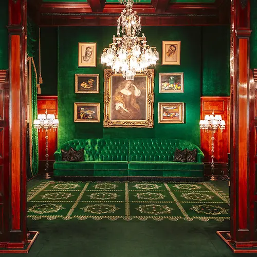 Hotel Sacher, green bench, green wall, pictures on the wall