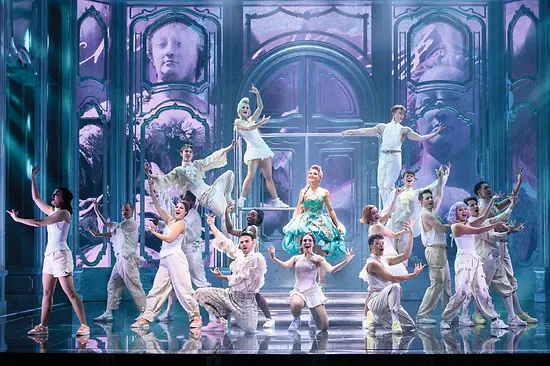 Maria Theresa in a green dress, surrounded by dancers in white costumes.